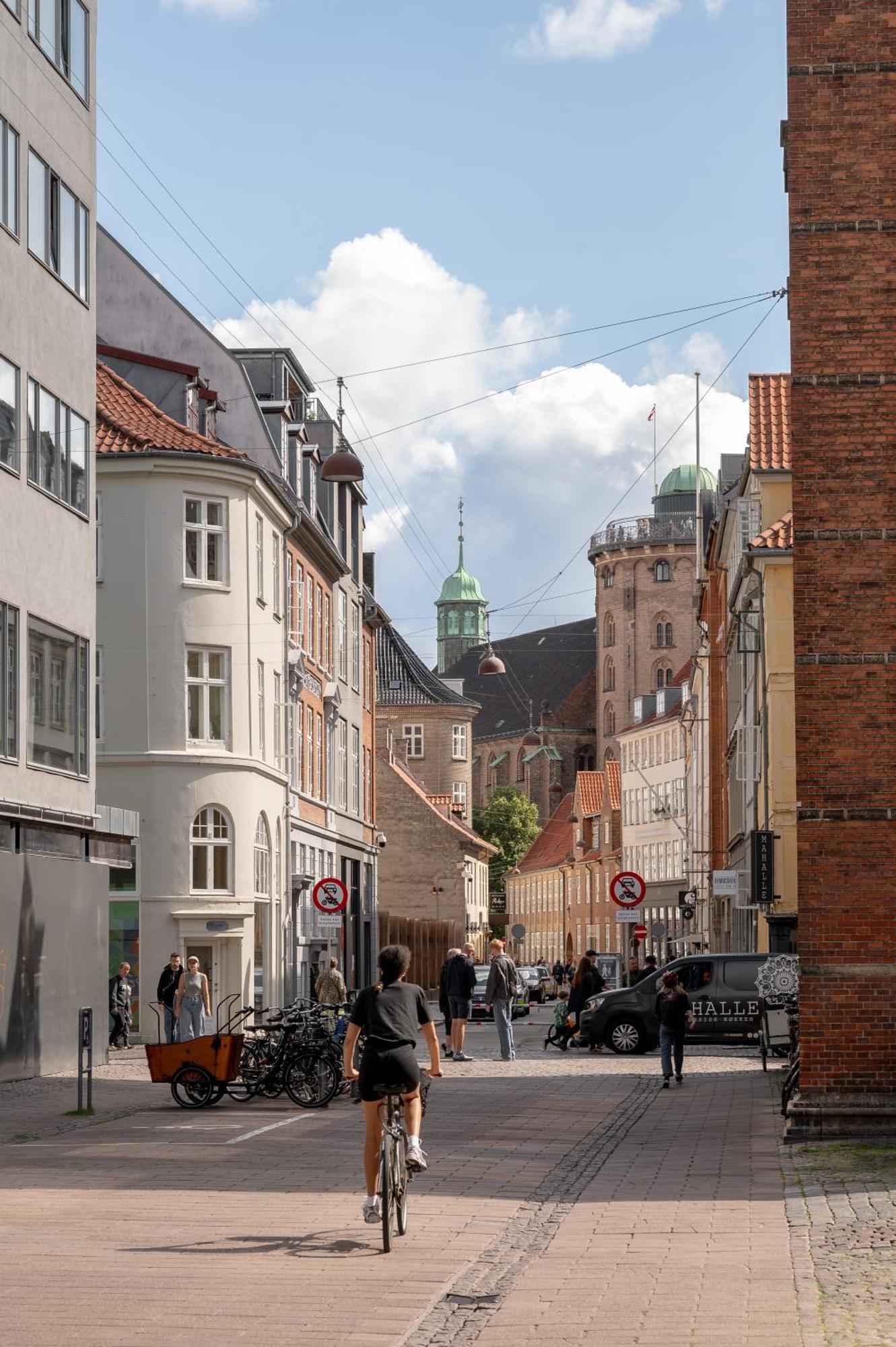 1 Hotel Copenhagen Exterior photo The street with the spire of the Church of Our Lady in the background